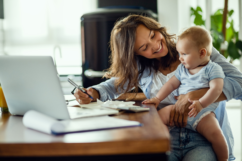 Mom plays with son while studying home budget